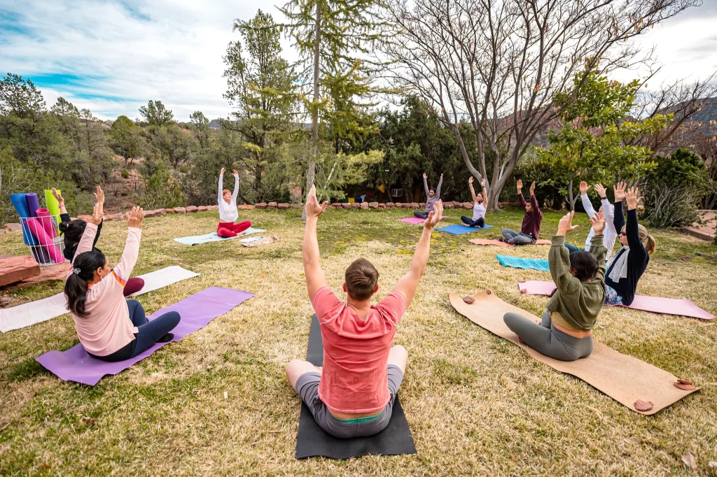 A group of yoga practitioners in a circle in Encinitas, capturing the wellness lifestyle of North County San Diego.