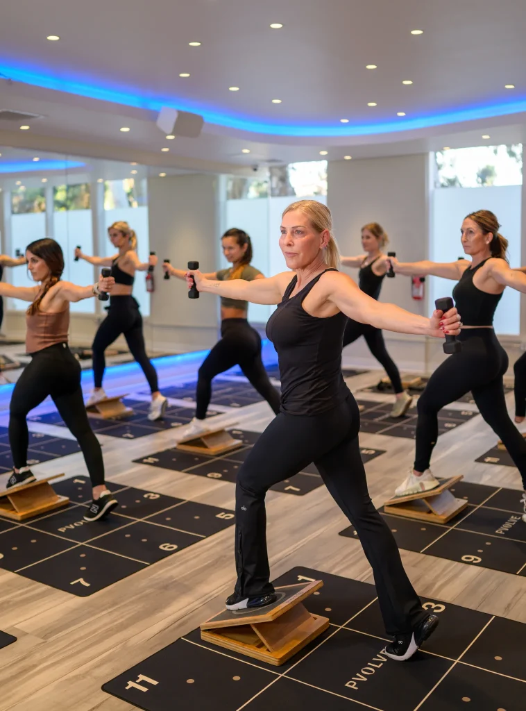 High-energy fitness lifestyle photography featuring a female athlete during a workout session in a modern gym.