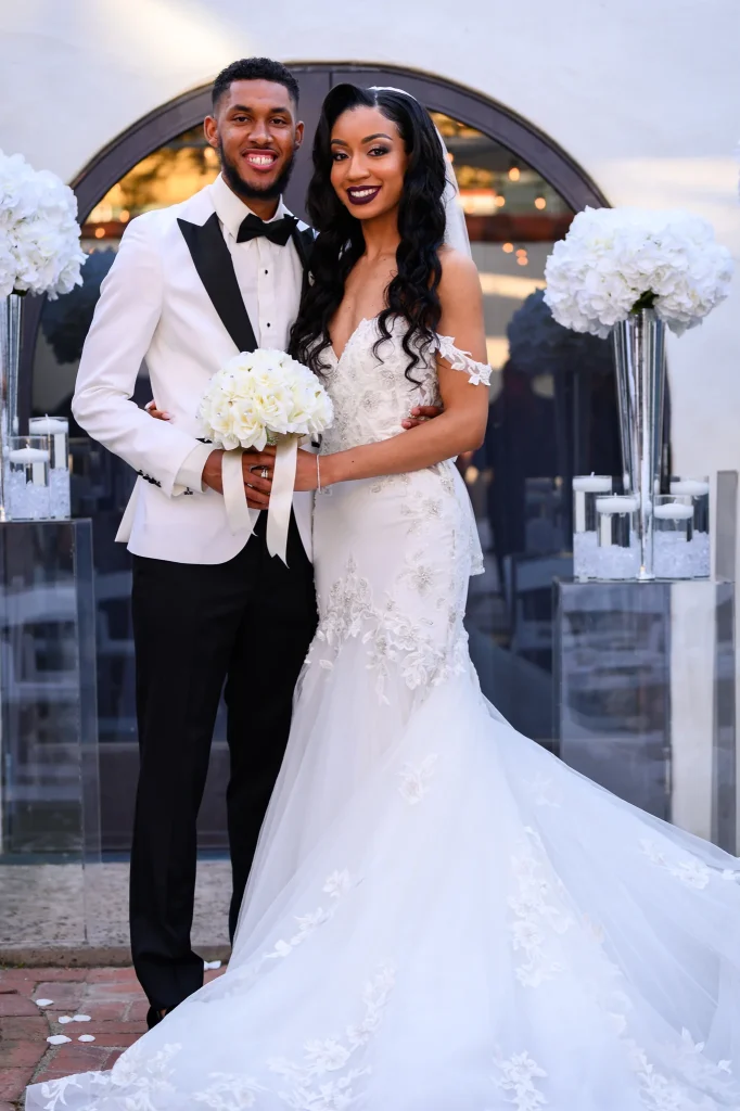 A stunning, high-end wedding portrait of an African American couple, showcasing elegant styling and cinematic lighting.