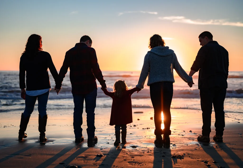 A creative golden hour silhouette of a family on a San Diego ridgeline by Noah Gilman Productions.