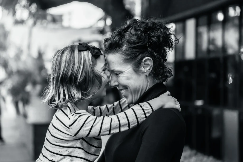 High-end family legacy photo still showcasing cinematic lighting and emotional connection between a mother and daughter.