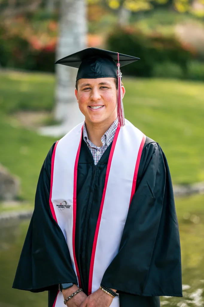 A confident, high-end graduation portrait of a young man celebrating his academic milestone.